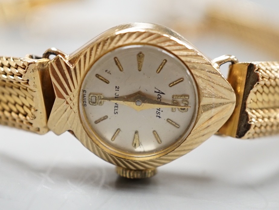 A lady's 9ct gold Accurist manual wind wrist watch, on a continental yellow metal bracelet, gross weight 21.2 grams.